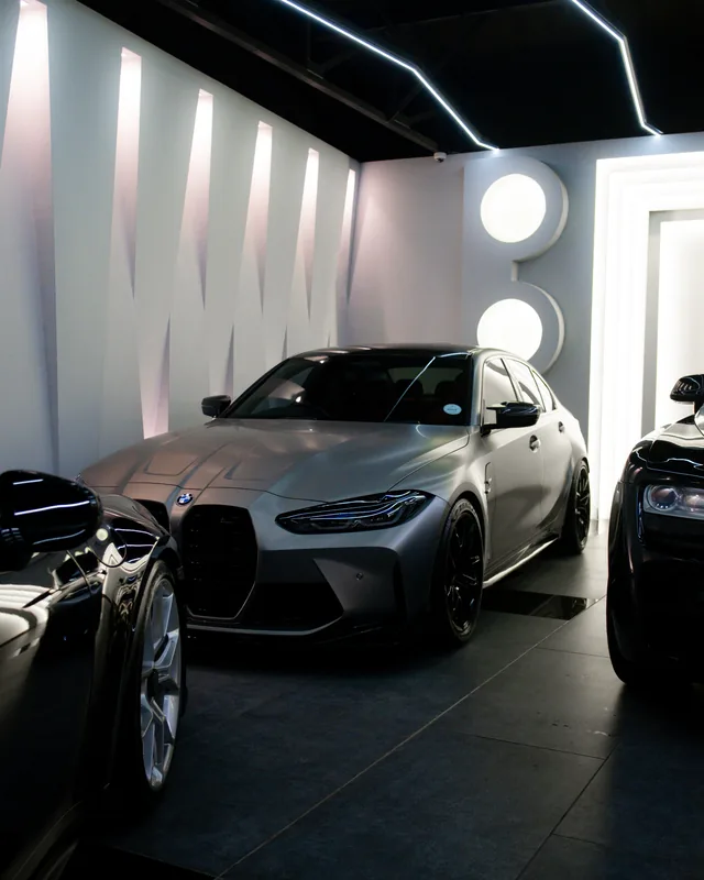 Grey BMW M3 Competition parked in the showroom